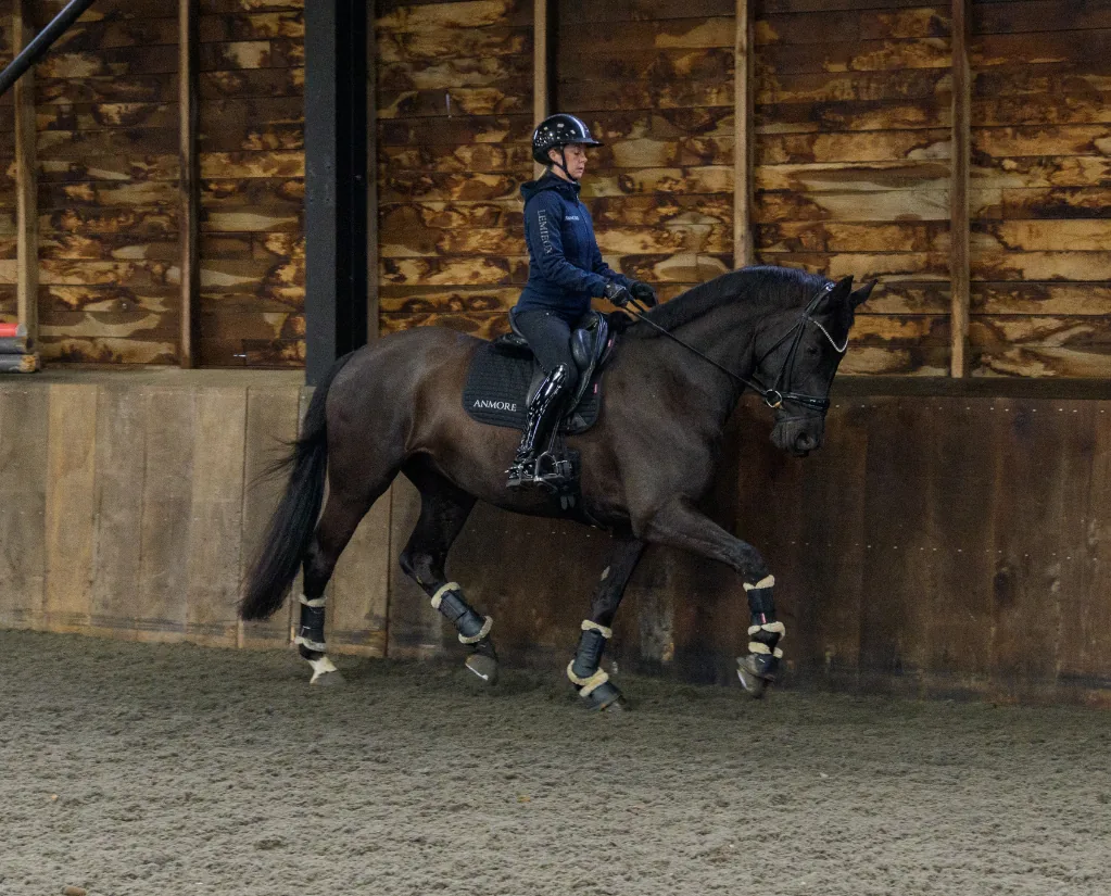 Lucy Palmer riding a dressage horse in the training arena at Anmore Dressage